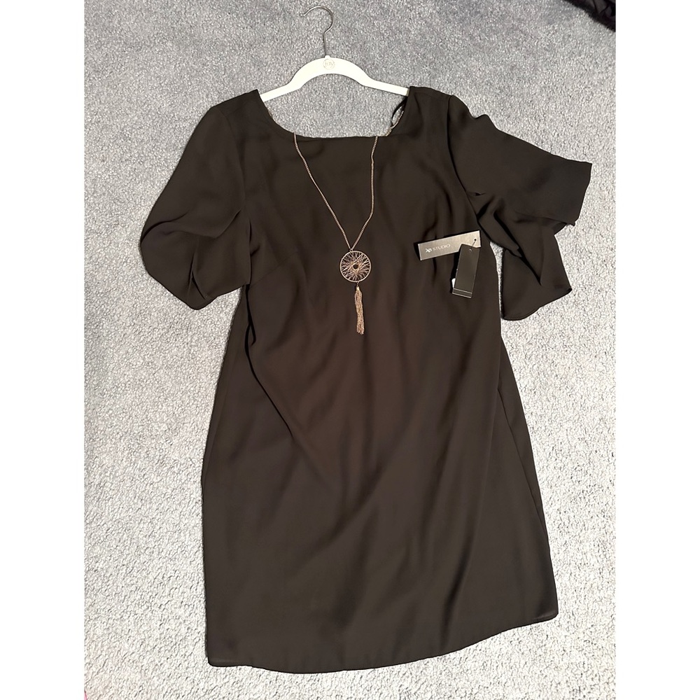 Black mini dress with gold necklace